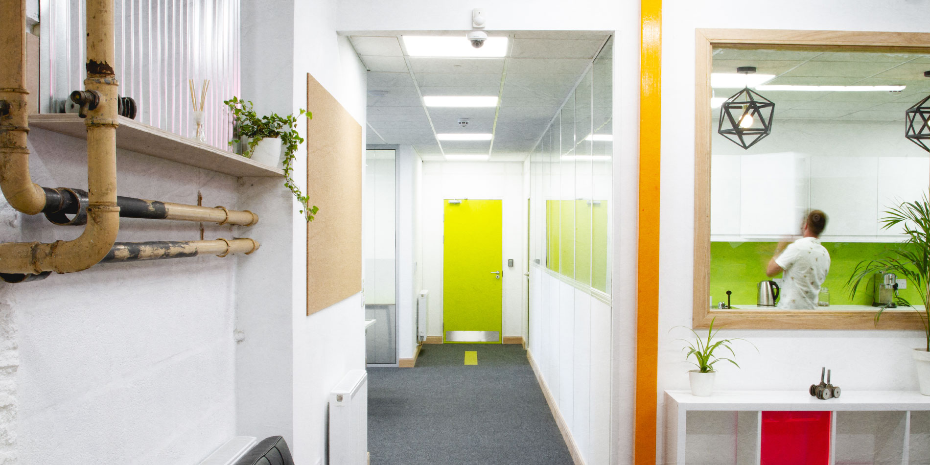 View down corridor and into kitchen with member opening cupboard