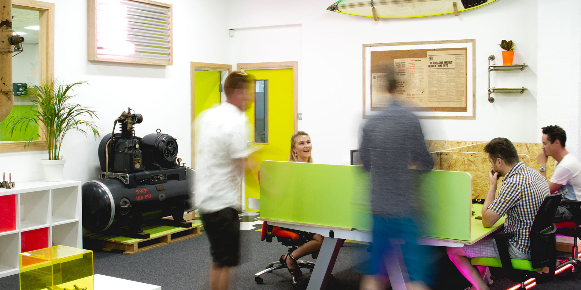 Members chatting around a coworking desk