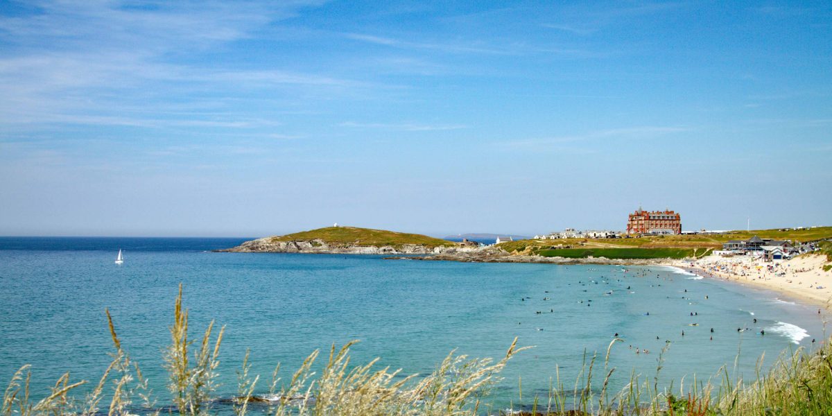 View of Fistrial Beach, blue sea, sand and people in the sea